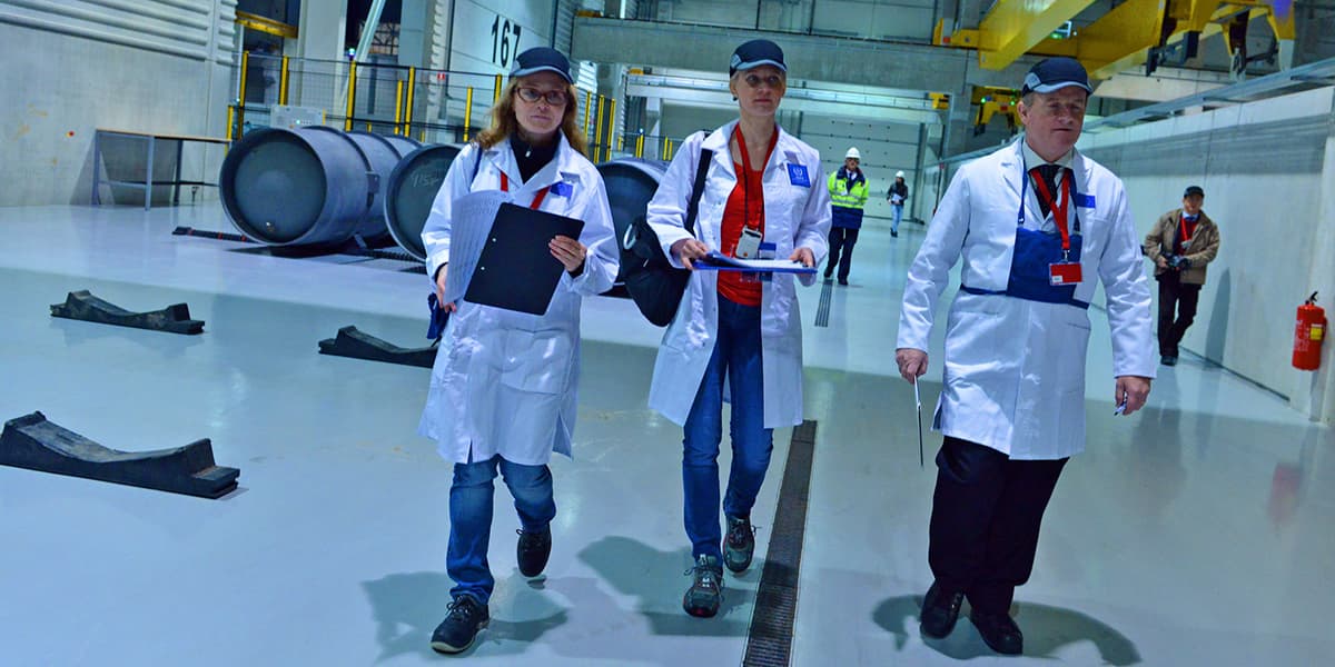 Three inspectors touring a nuclear facility